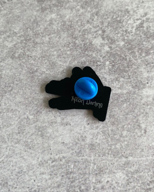 Back view of Immortal Shadow Divine Dogs Inspired Soft Enamel Pin featuring a blue rubber clutch and 'Neon Darling' branding on gloss black metal.